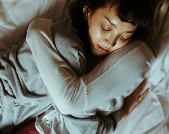 A relaxing moment of affection and tranquility shared by a couple embracing in bed.